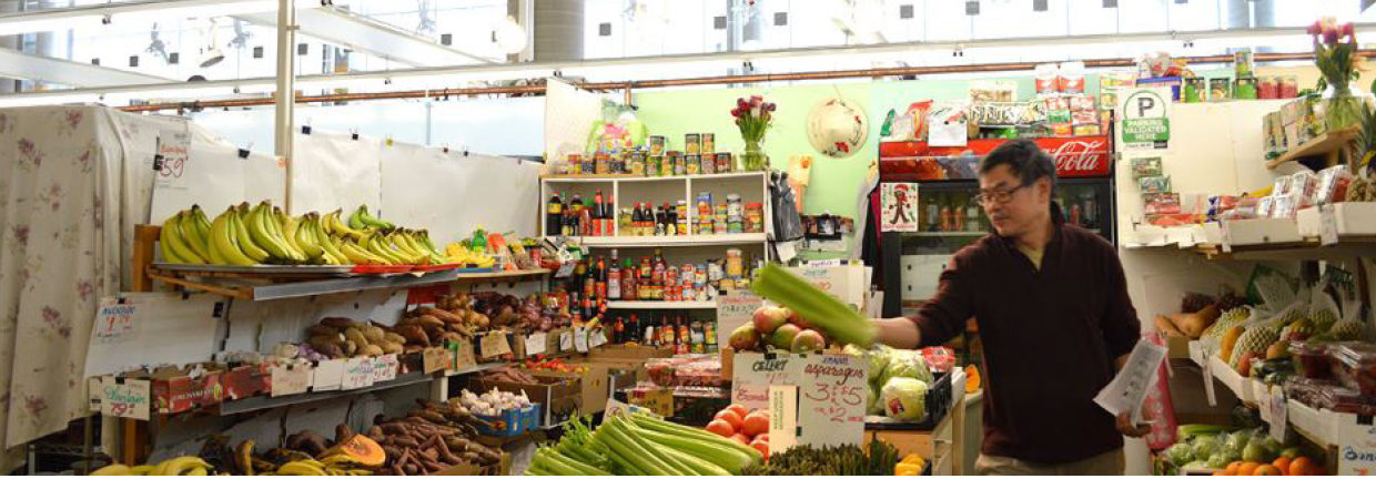 Lee stands over his display of fresh produce