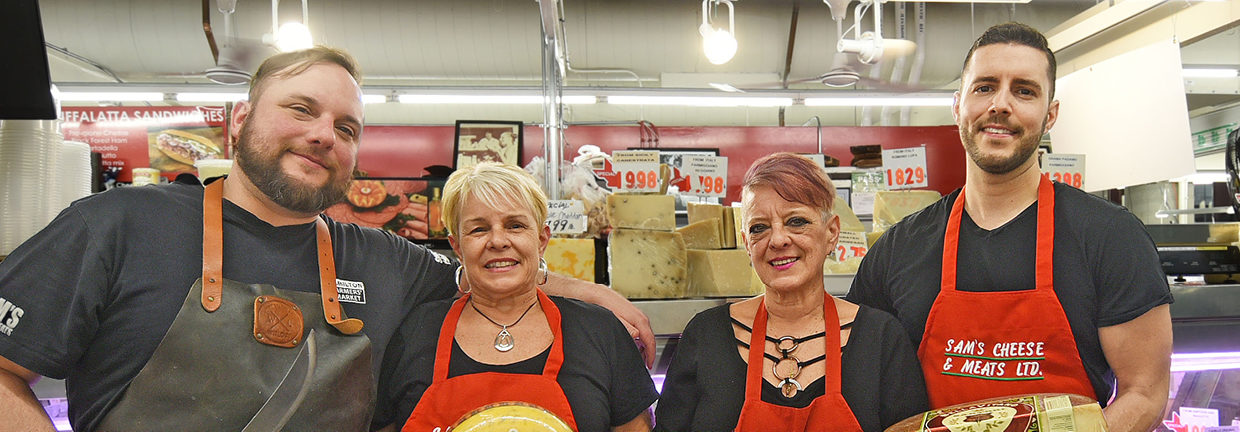 Family poses which of the third and generation owners of Sam's Cheese & Meats
