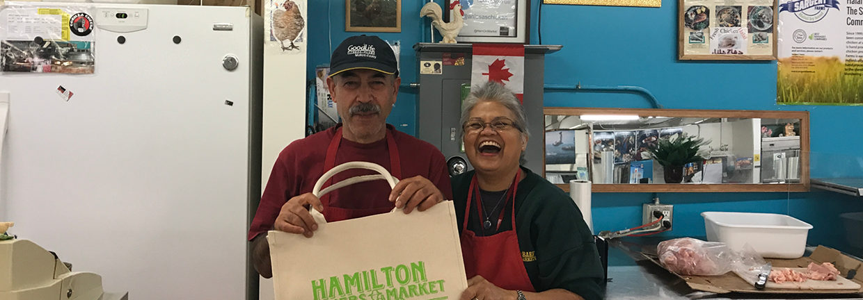 Owners stand on front of their display of poultry