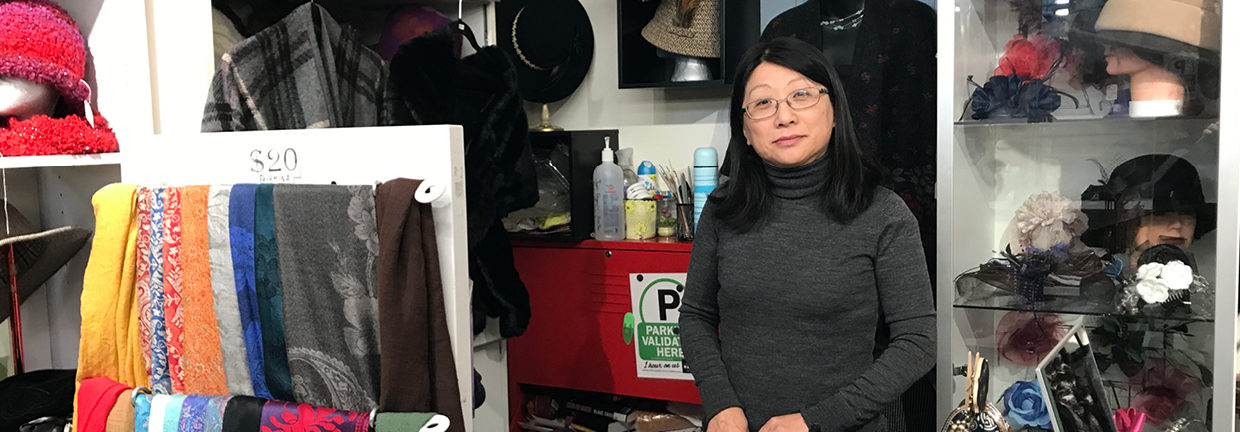Owner Jean stands proudly with her handmade display of hats, scarfs, etc..