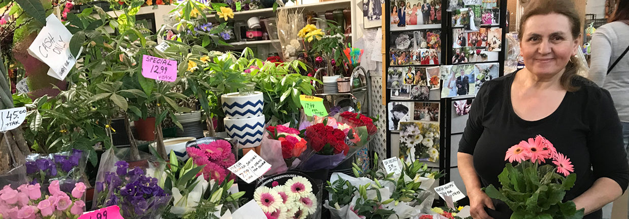 Josie standing on front of her beautiful stall display of colourful flowers