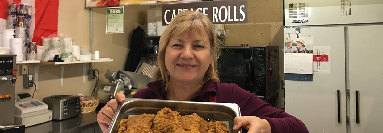 Anna holding her famous cabbage rolls ready for lunch