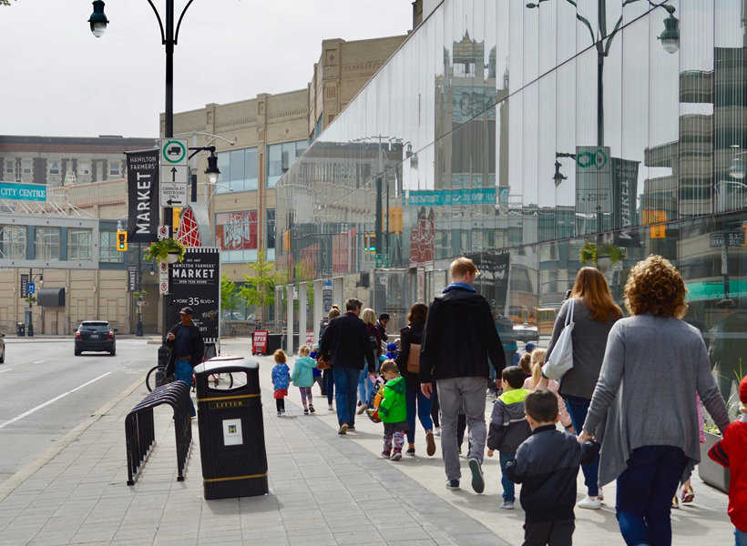 Kids & Parents walking along York Blvd to the entrance of the Hamilton Farmers' Market.